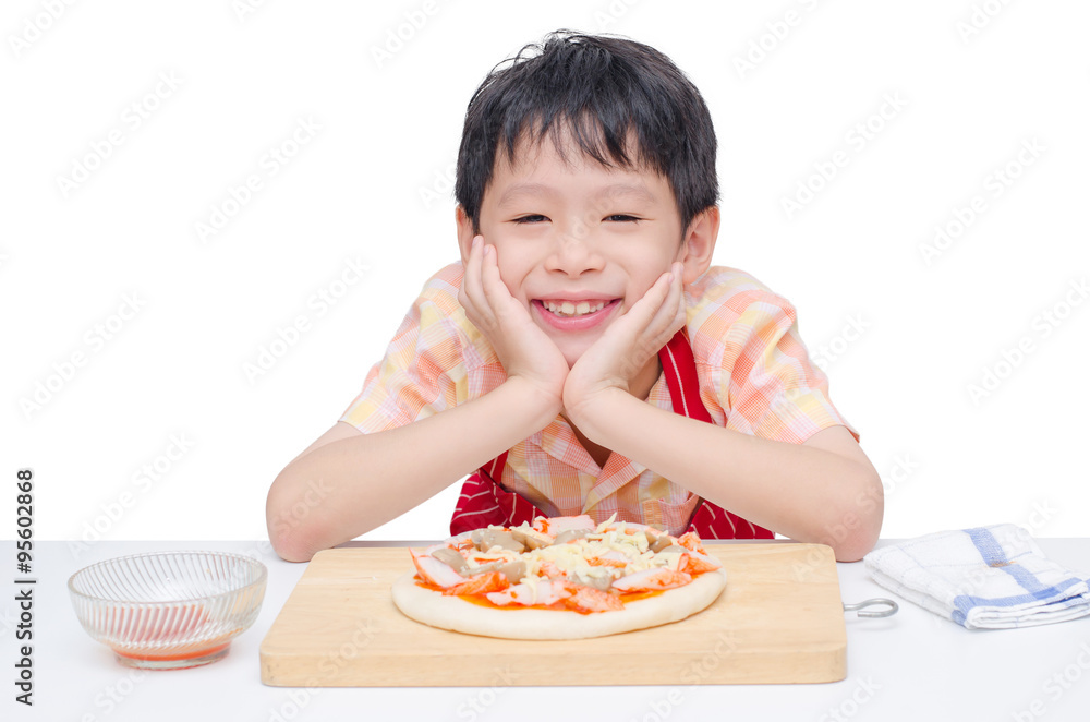 Asian boy cooking pizza on table Asian boy cooking pizza on table
