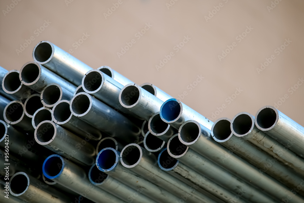 Fototapeta premium Stack of Many Pipes at the Construction Site