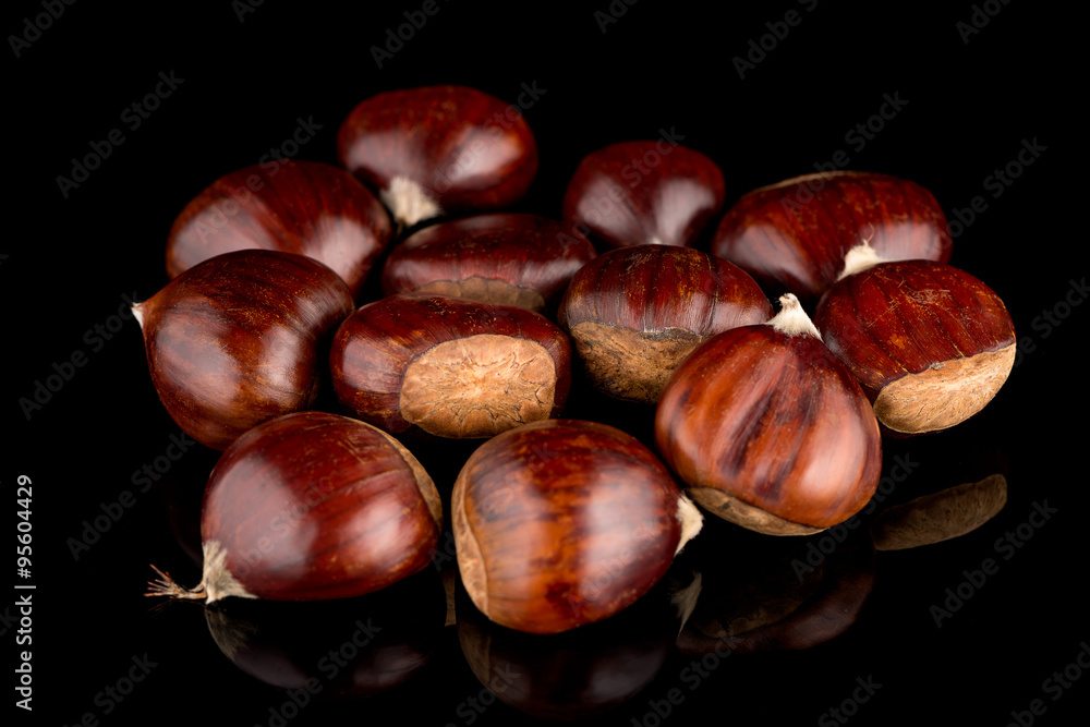 Chestnuts on a black reflective background Chestnuts on a black reflective background