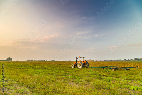 tractor and harvested land