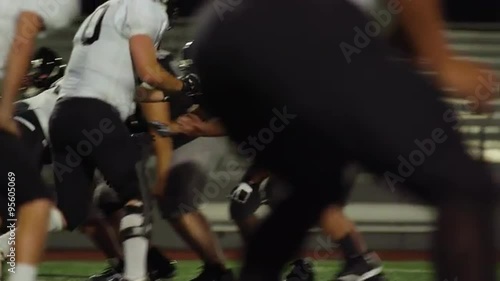 A football player jumps over his opponents to make a touchdown, slow motion