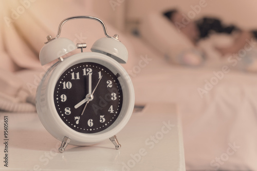 alarm clock on the bed in bedroom, retro style