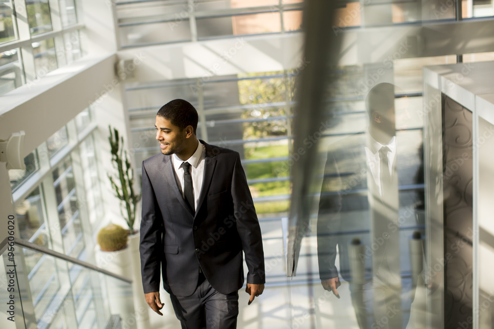 Young black man walking in the office Young black man walking in the office