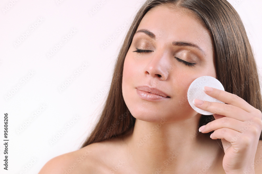 beautiful young woman cleaning her skin on white background beautiful young woman cleaning her skin on white background