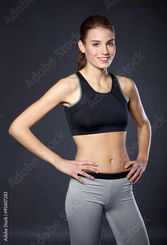Portrait athletic girl on a black background