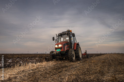 Tractor plowing field