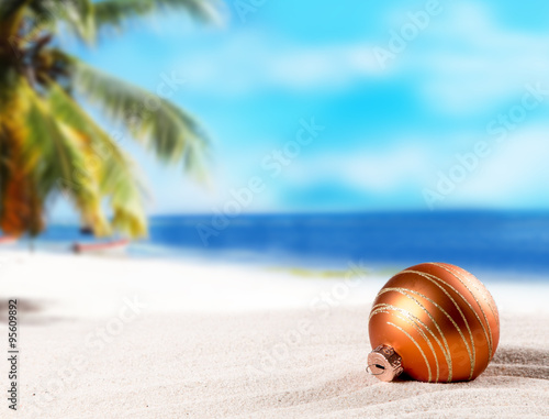Christmas ornament on a beach,concept of a warm, tropical weather Christmas