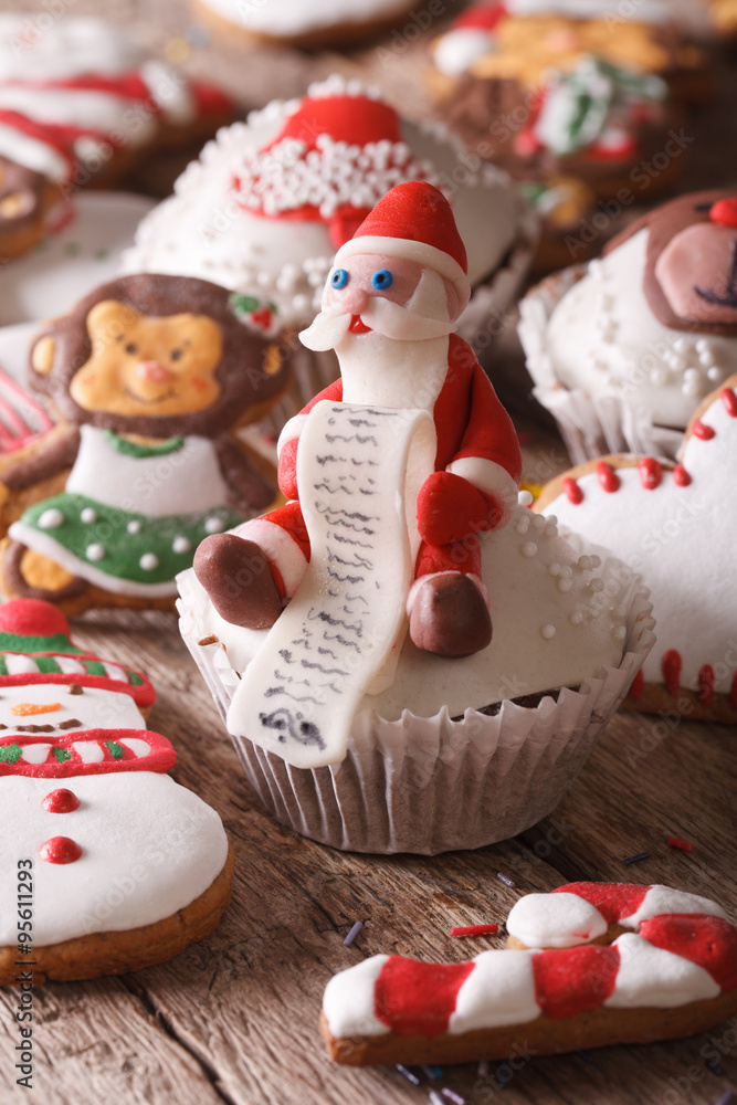 Christmas cupcakes and gingerbread macro on a wooden table. Vertical
