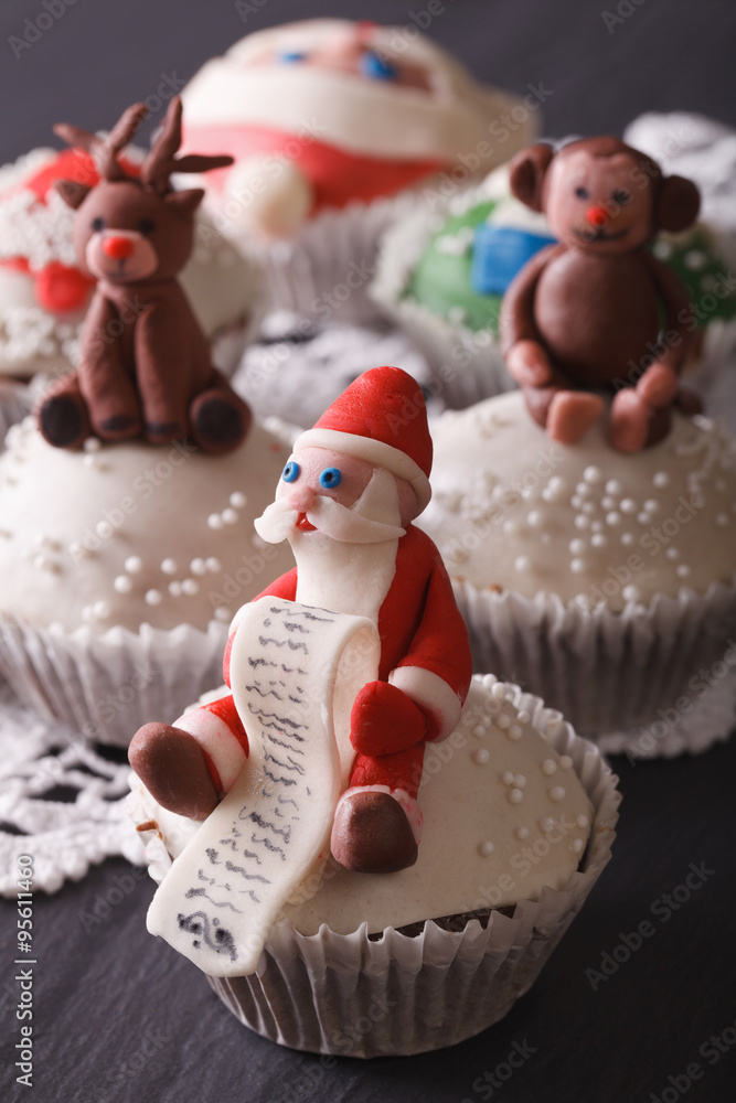 Christmas cupcakes decorated with the figure of Santa closeup. vertical

