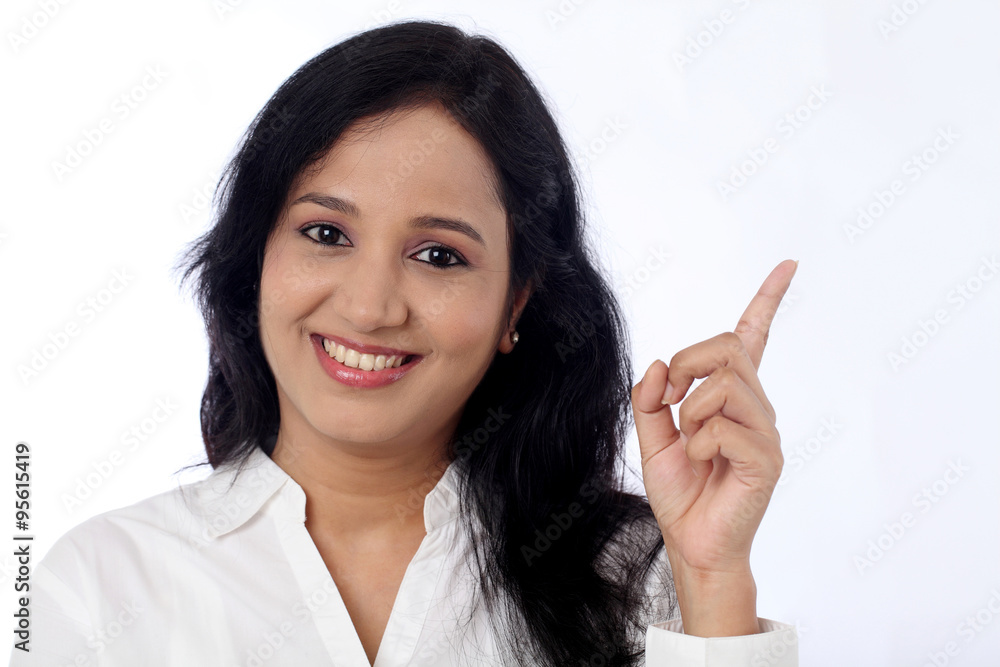 Happy young business woman pointing at copy space Happy young business woman pointing at copy space