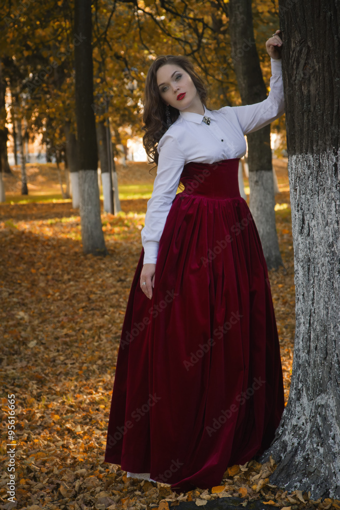 Woman dressed in a retro-style on the autumn alley Woman dressed in a retro-style on the autumn alley