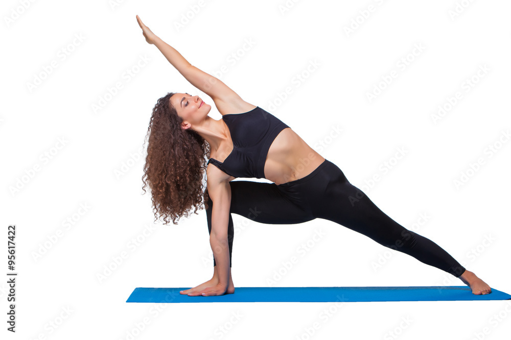 Studio shot of a young fit woman doing yoga exercises. Studio shot of a young fit woman doing yoga exercises.