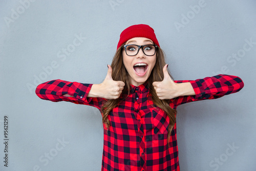 Cheerful hipster woman showing thumbs up photo