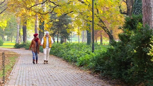 Wallpaper Mural Romantic young couple walking in the park, walking, kissing and holding hands. Slow motion. Torontodigital.ca