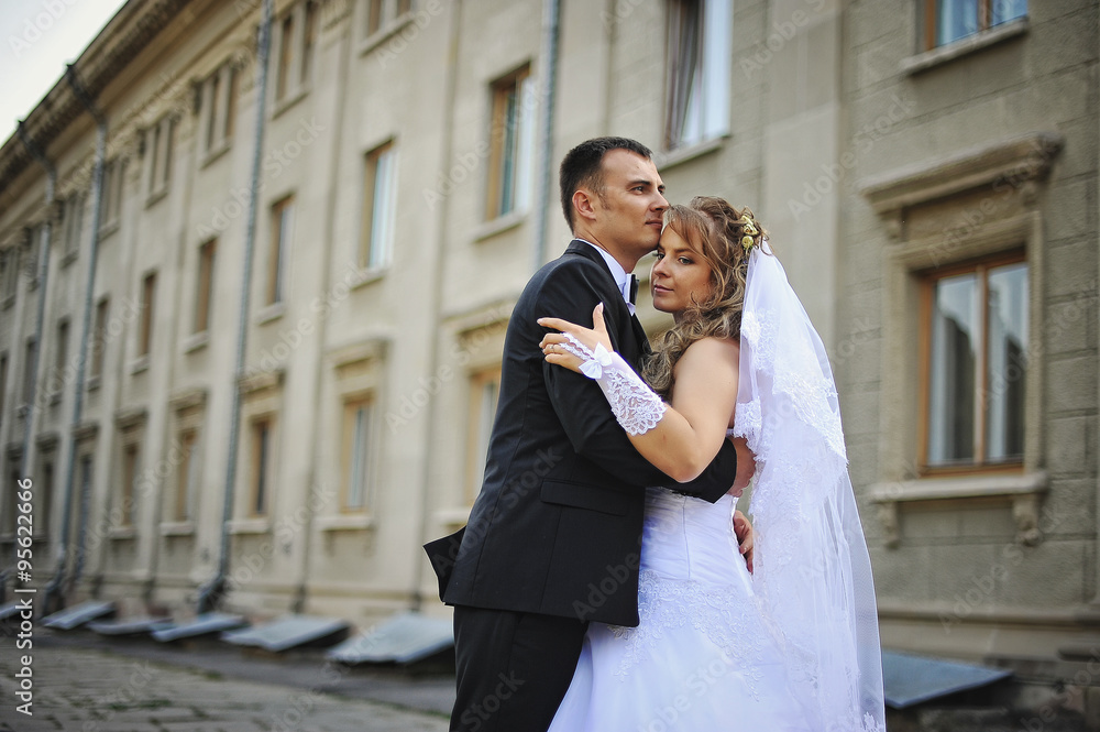 wedding couple embrace background old architecture