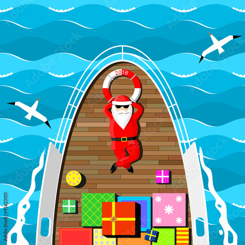 Santa Claus on a yacht. Santa Claus carries gifts lying on the deck of the yacht at sea. 