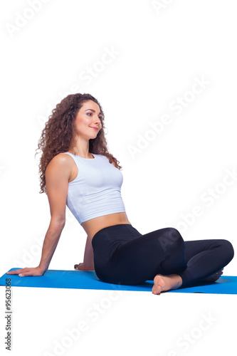 Studio shot of a young fit woman doing yoga exercises.