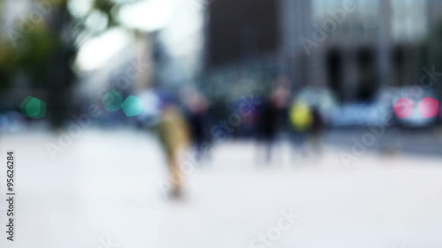 slow motion of an anonymous skater riding in the street in urban blurred and out of focus context photo