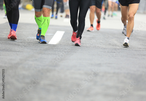  marathon runners running on city road
