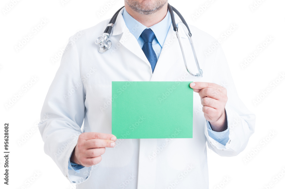 Anonymous doctor or medic holding green blank paper Anonymous doctor or medic holding green blank paper
