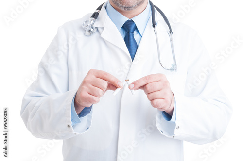 Anonymous doctor or medic breaking cigarette as quit smoking ges