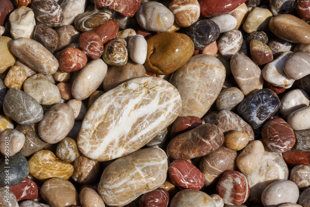 Wet stones pebbles on the Mediterranean coast of the island of Rhodes. Wet stones pebbles on the Mediterranean coast of the island of Rhodes.