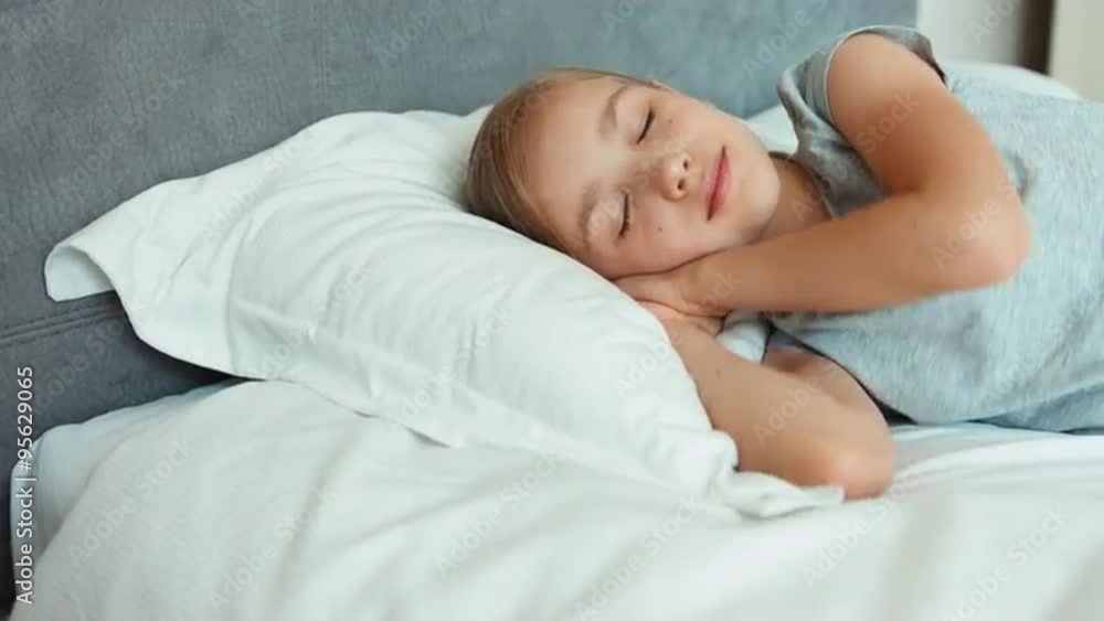Closeup portrait girl sleeping in a bed and smiling Closeup portrait girl sleeping in a bed and smiling