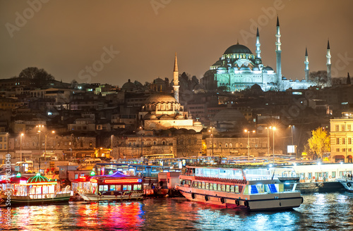 Photography Istanbul skyline from Galata bridge over Golden Horn by night, with Suleymaniye