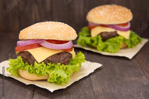 Hamburger with Lettuce and Cheese on wooden table
