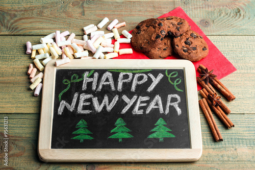 drawing Board and cookies with cinnamon and anise on wooden background photo