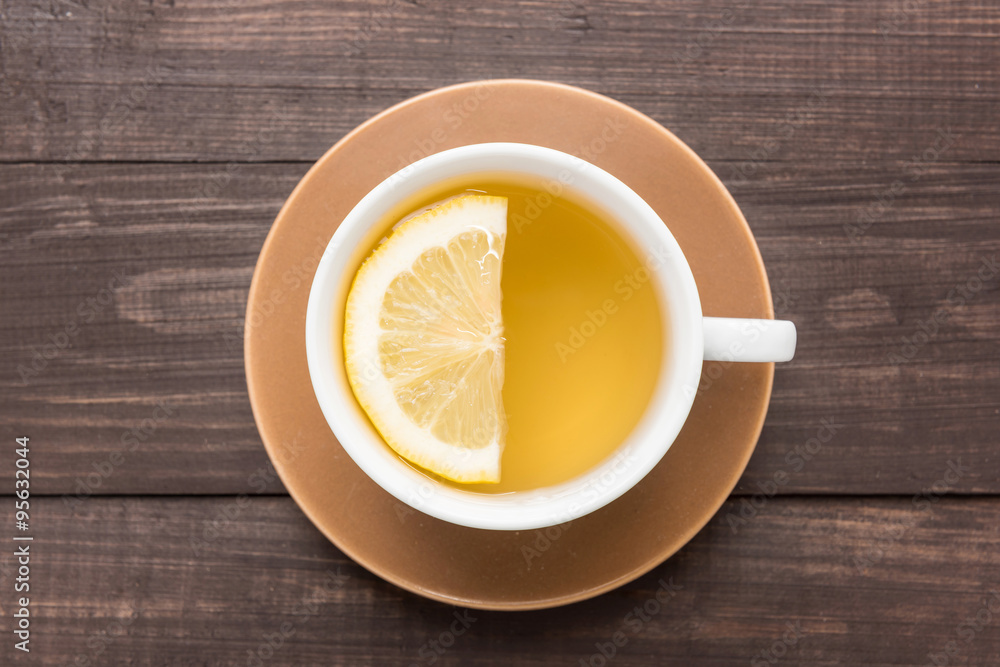 Ginger tea with lemon on the wooden background Ginger tea with lemon on the wooden background