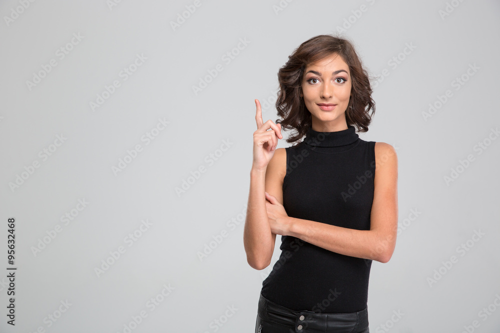Young beautiful woman pointing up and having an idea Young beautiful woman pointing up and having an idea