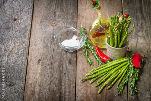 Still life with olive oil asparagus, avocado, pepper and rosemar photo