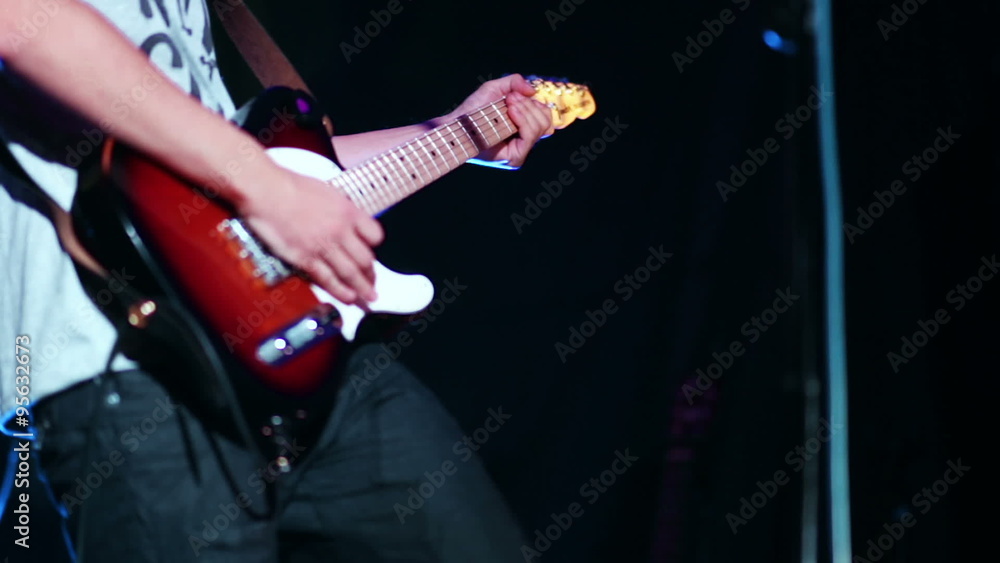 Man hands playing electric guitar at the concert Man hands playing electric guitar at the concert