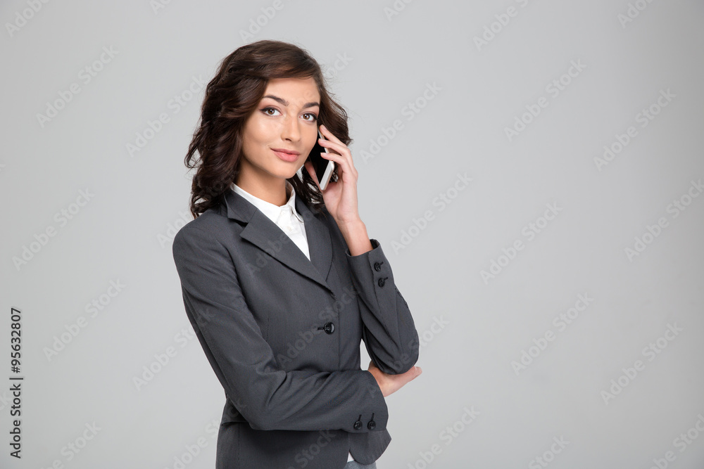 Beautiful business woman talking on mobile phone Beautiful business woman talking on mobile phone