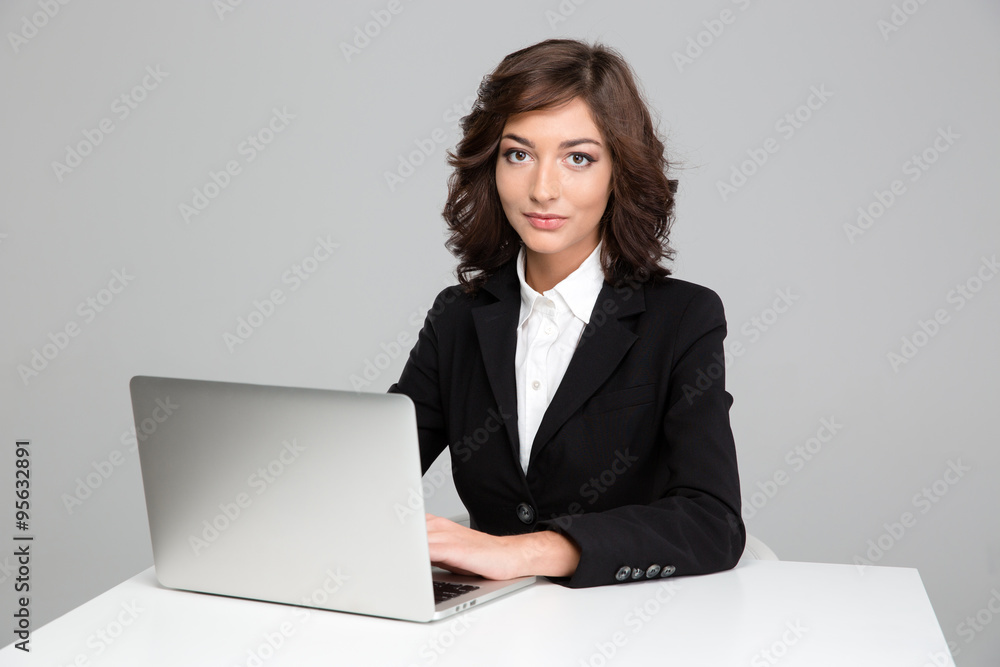 Confident beautiful business woman working using laptop Confident beautiful business woman working using laptop