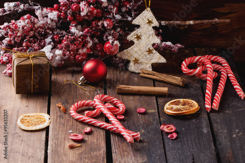 Christmas candies on rustic wooden board photo