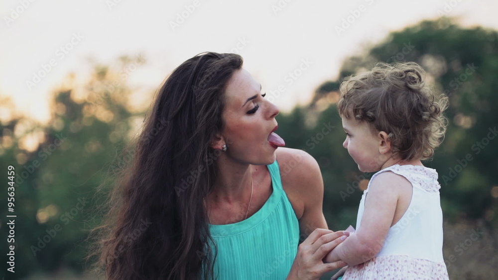 beautiful mother and her pretty little daughter having fun outdoors beautiful mother and her pretty little daughter having fun outdoors