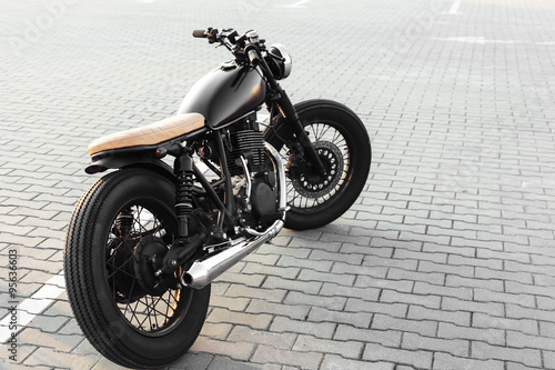 Vintage motorcycle in parking lot during sunset photo