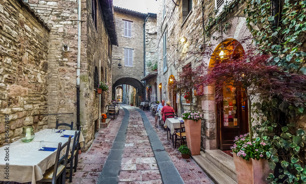 Romantic dinner place in a beautiful alley in the ancient town of Assisi, Umbria, Italy
