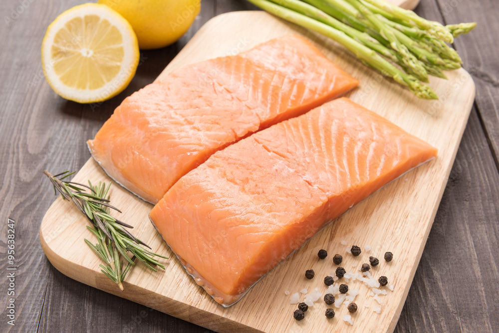 Fresh salmon fillet with spice on wooden table Fresh salmon fillet with spice on wooden table