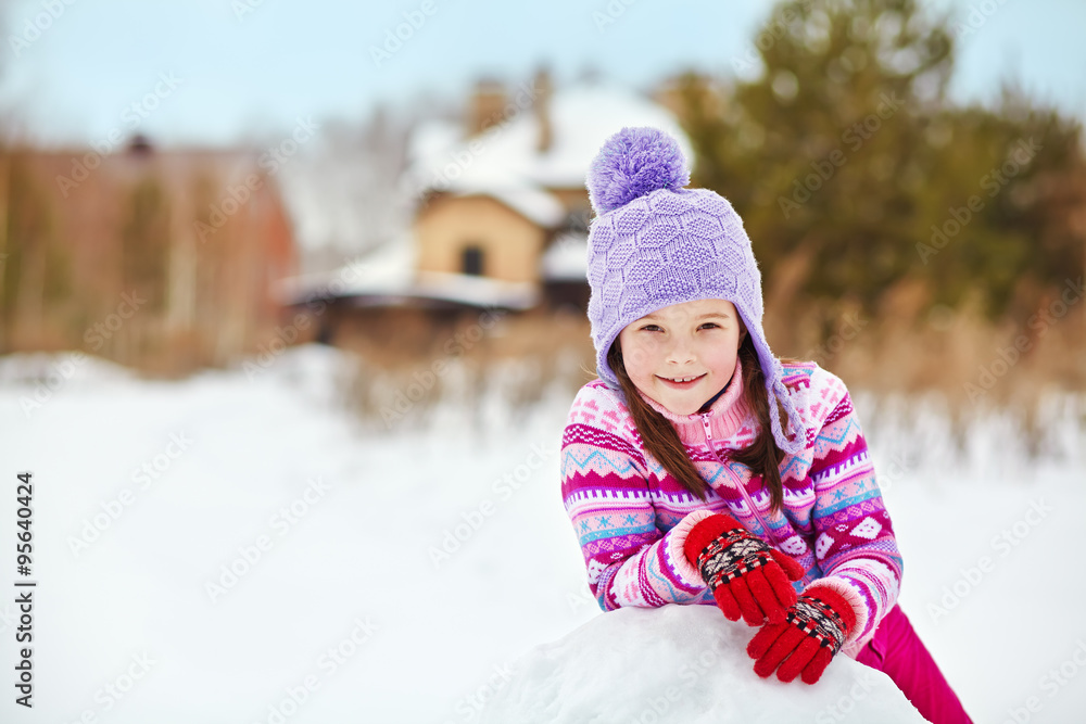 kid playing with snowman