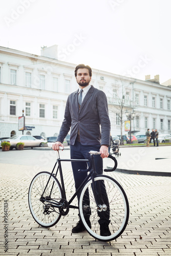 young caucasian businessman with bicycle