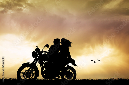 Fototapeta Naklejka Na Ścianę i Meble -  couple kissing on motorbike