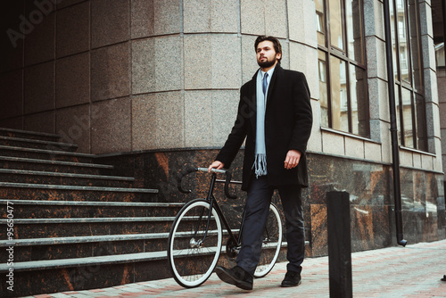 young caucasian businessman with bicycle