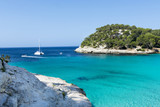 View of Macarella bay in Menorca during a summer day with blue sky a transparent water, Balearic Islands, Spain