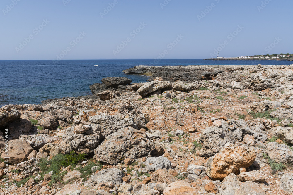 View of the rocky coast in Menorca in a summer day with blue sky and blue water, Menorca, Balearic Islands, Spain