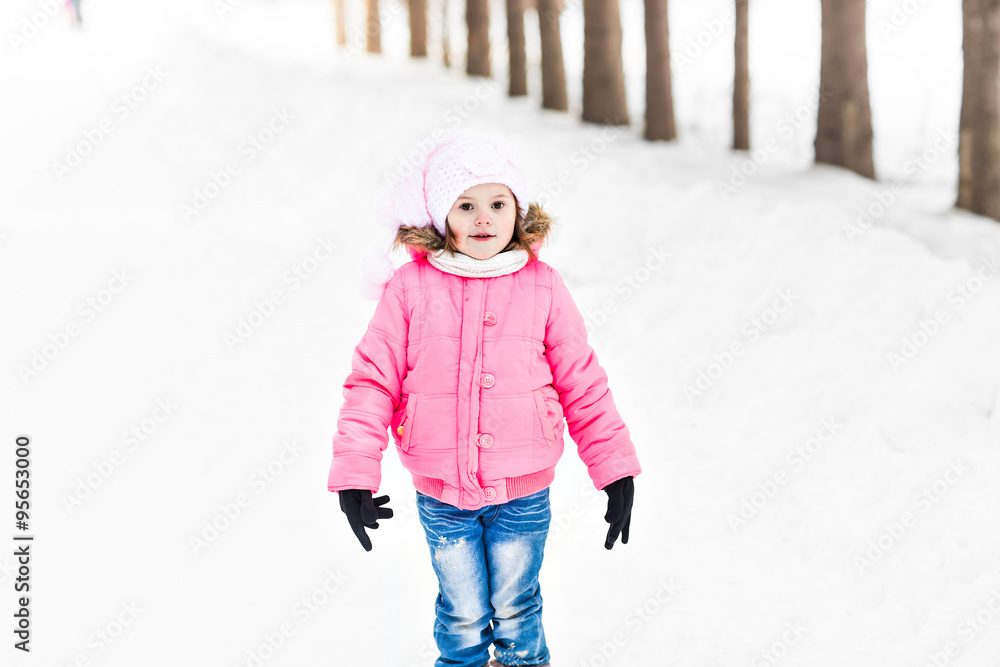 Happy baby girl in a winter park
