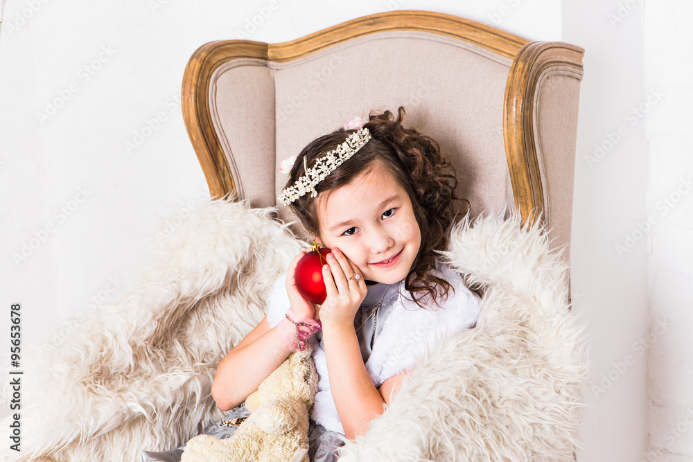 Cute girl holding decorative red christmas ball Cute girl holding decorative red christmas ball