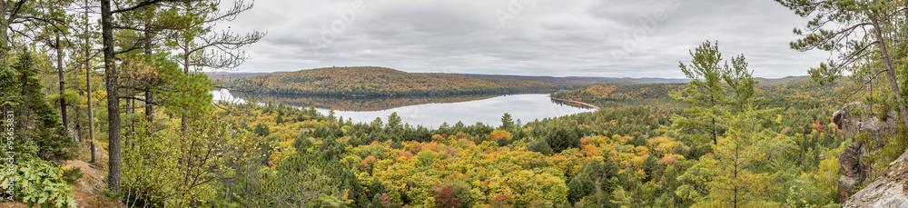Panorama Looking Out Over a Lake Surrounded by Forest in Autumn